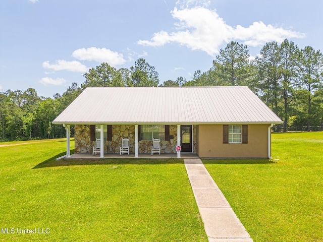 28121 Dusty Ln, Picayune, MS 39466 - view of front of home featuring a front yard, covered porch, stone siding, and metal roof