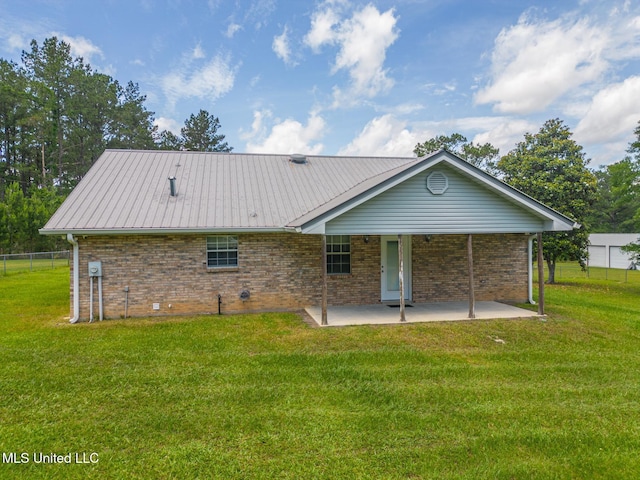 28121 Dusty Ln, Picayune, MS 39466 - back of house featuring a patio area, brick siding, and metal roof