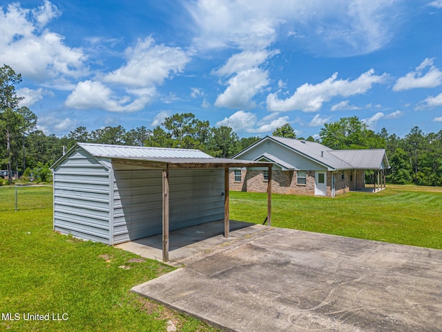 28121 Dusty Ln, Picayune, MS 39466 - garage with driveway and a carport
