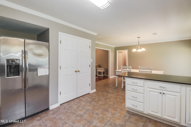 28121 Dusty Ln, Picayune, MS 39466 - kitchen with stainless steel fridge with ice dispenser, dark countertops, white cabinets, a chandelier, and crown molding