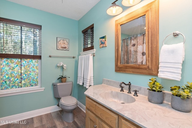 bathroom featuring toilet, vanity, a textured ceiling, and hardwood / wood-style flooring