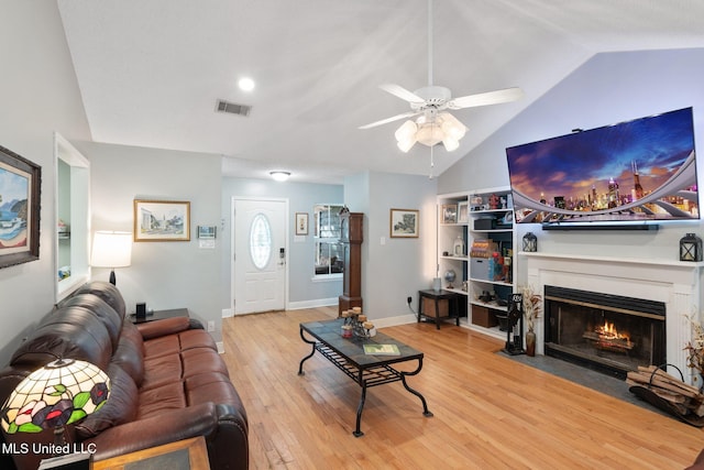 living room with vaulted ceiling, ceiling fan, and light hardwood / wood-style floors