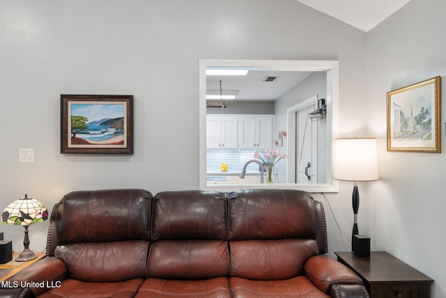 living room with sink and vaulted ceiling