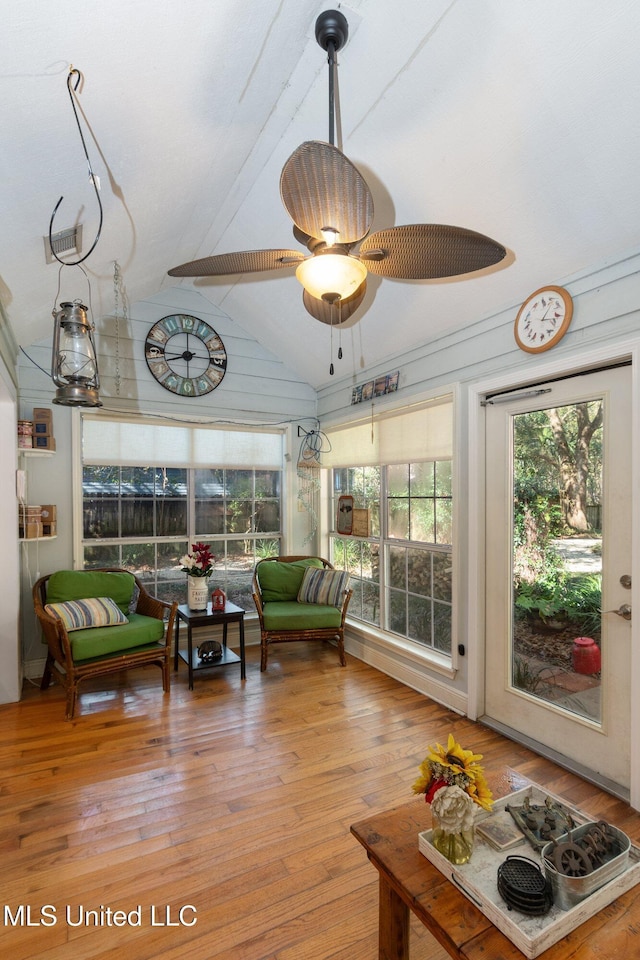 sunroom / solarium with lofted ceiling and ceiling fan