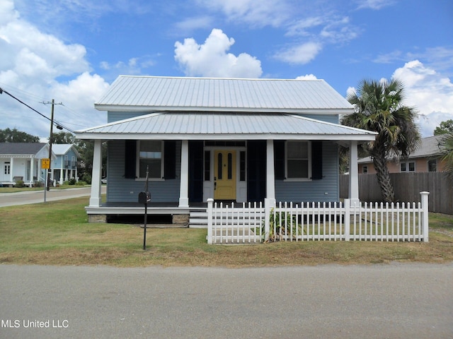 farmhouse inspired home featuring a front yard and a porch