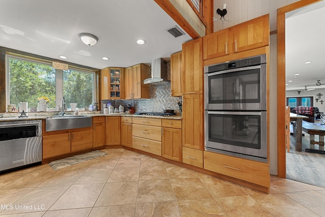 19640 Busby Rd, Vancleave, MS 39565 - kitchen with wall chimney range hood, tasteful backsplash, a sink, appliances with stainless steel finishes, and visible vents