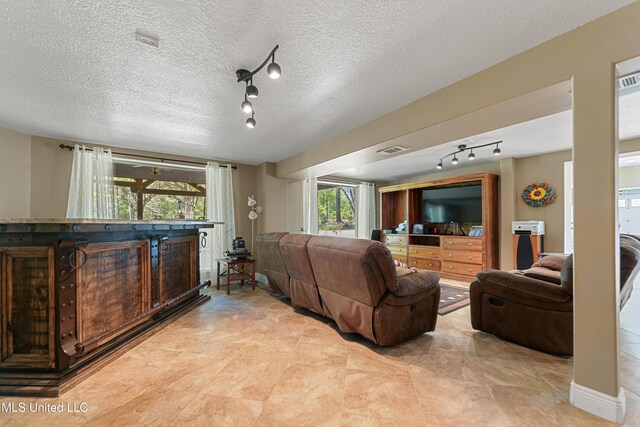19640 Busby Rd, Vancleave, MS 39565 - living room featuring track lighting, visible vents, and a textured ceiling