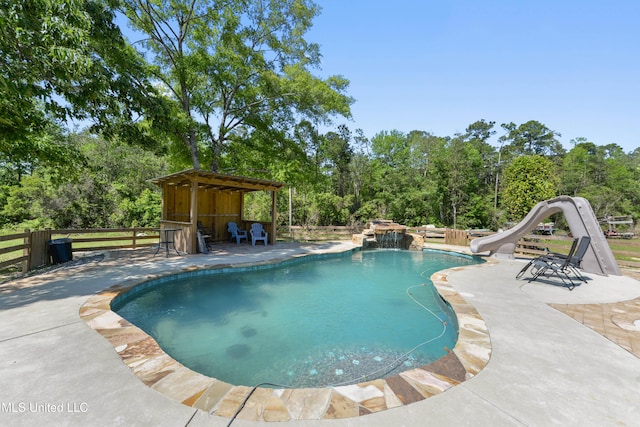 19640 Busby Rd, Vancleave, MS 39565 - pool featuring a water slide, fence, and a patio
