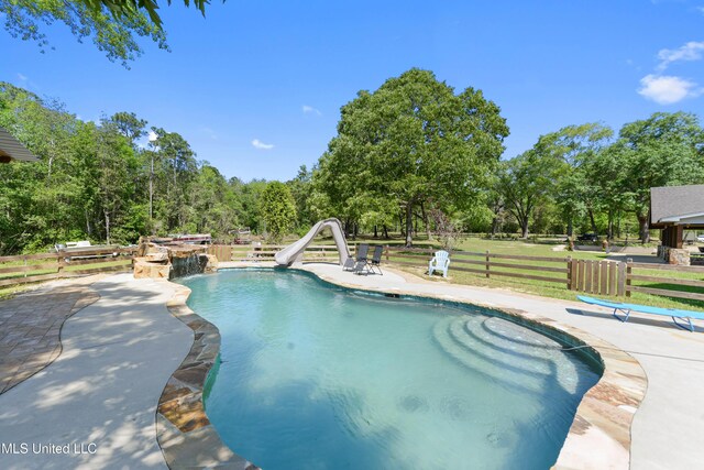 19640 Busby Rd, Vancleave, MS 39565 - outdoor pool with a water slide, fence, and a patio area