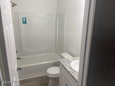 713 Cypress Ln Unit A & B, Picayune, MS 39466 - full bathroom featuring toilet, vanity, tub / shower combination, and wood-type flooring