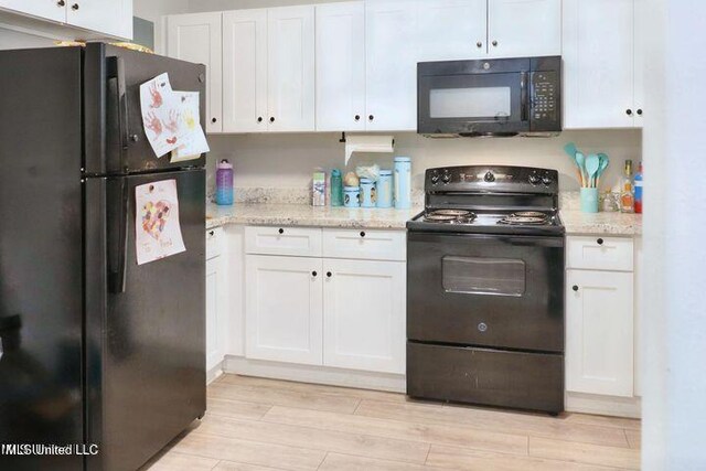713 Cypress Ln Unit A & B, Picayune, MS 39466 - kitchen with white cabinetry, black appliances, light stone countertops, and light hardwood / wood-style flooring