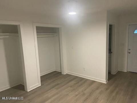 713 Cypress Ln Unit A & B, Picayune, MS 39466 - unfurnished bedroom with dark hardwood / wood-style flooring