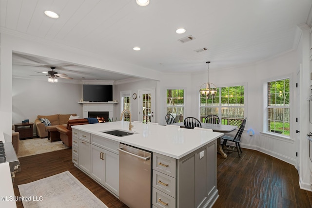 32 Cambrooke, Hattiesburg, MS 39402 - kitchen with a sink, dishwasher, a warm lit fireplace, a kitchen island with sink, and recessed lighting