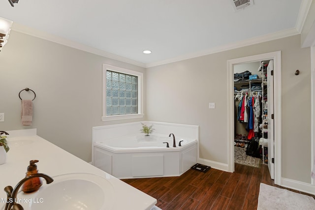 32 Cambrooke, Hattiesburg, MS 39402 - bathroom featuring wood finished floors, ornamental molding, baseboards, a bath, and recessed lighting