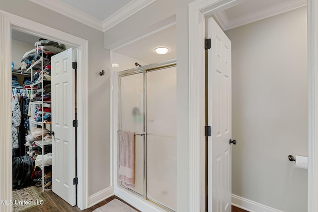 32 Cambrooke, Hattiesburg, MS 39402 - bathroom featuring wood finished floors, a stall shower, ornamental molding, a spacious closet, and baseboards
