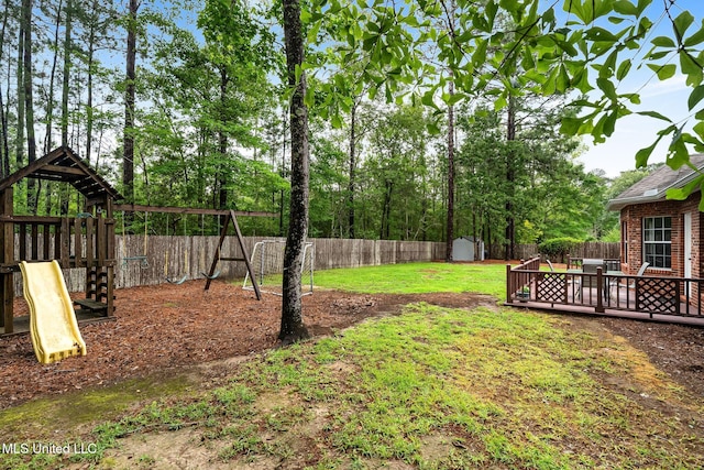 32 Cambrooke, Hattiesburg, MS 39402 - view of yard with a playground, a storage unit, an outdoor structure, and a wooden deck