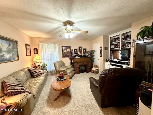 living room with ceiling fan, carpet flooring, and a textured ceiling