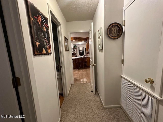 hallway with a textured ceiling