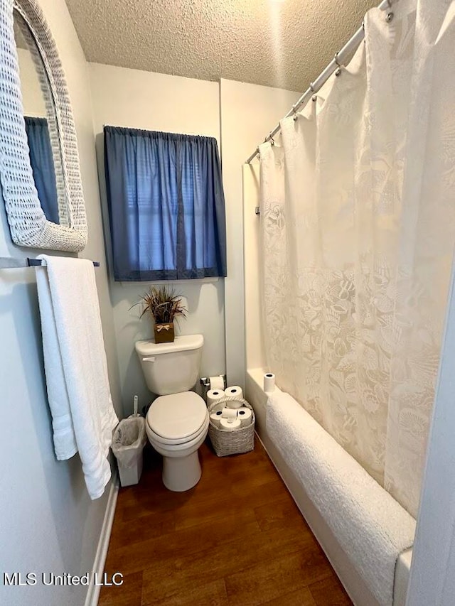 bathroom featuring toilet, a textured ceiling, and hardwood / wood-style floors