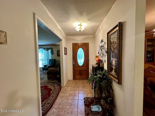 entryway featuring a textured ceiling and light tile patterned flooring