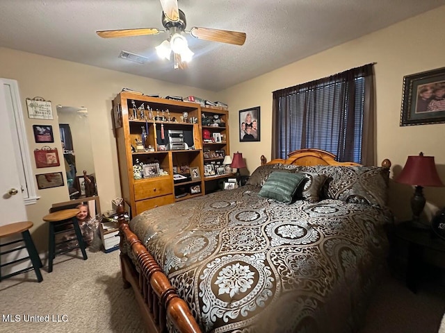 bedroom with carpet, a textured ceiling, and ceiling fan