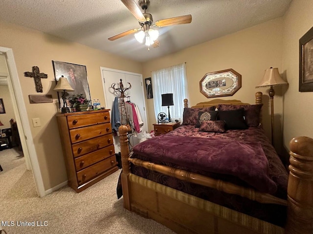 carpeted bedroom featuring a textured ceiling and ceiling fan