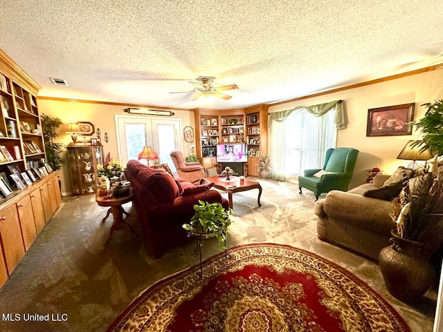 living room with ornamental molding, a textured ceiling, carpet floors, and ceiling fan