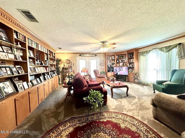 sitting room featuring carpet floors, a textured ceiling, and ceiling fan