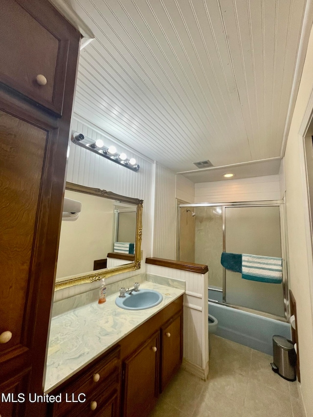 full bathroom featuring vanity, toilet, combined bath / shower with glass door, and wood ceiling