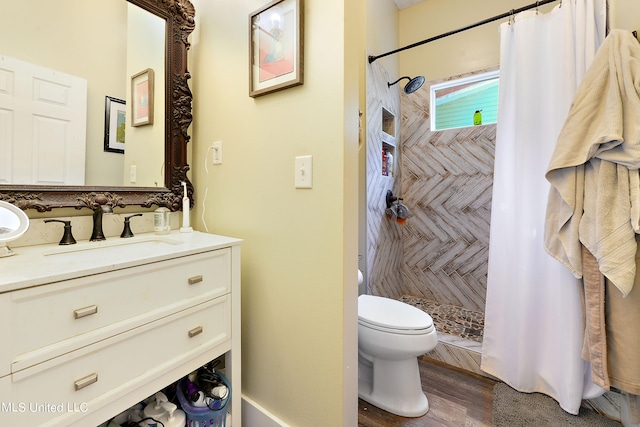 bathroom with vanity, curtained shower, wood-type flooring, and toilet