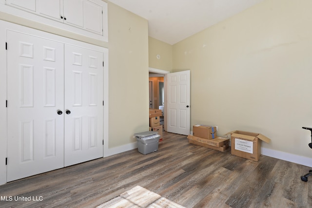 unfurnished bedroom featuring a closet and dark hardwood / wood-style flooring