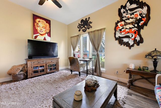 living room featuring wood-type flooring and ceiling fan