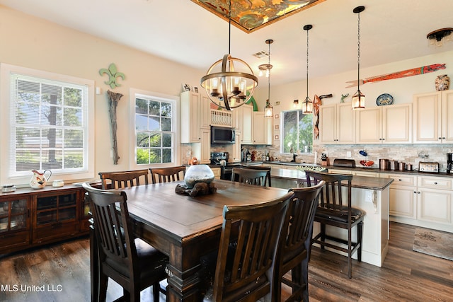 dining room featuring a notable chandelier and dark hardwood / wood-style flooring