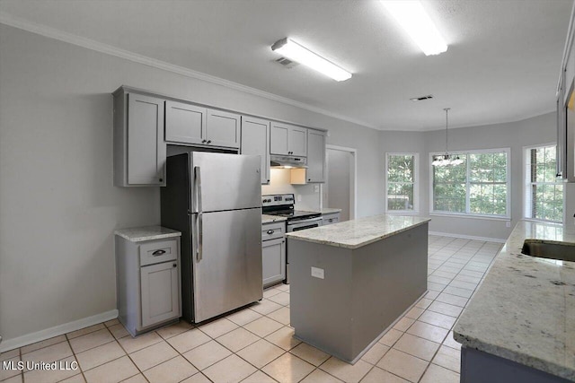 kitchen with appliances with stainless steel finishes, gray cabinetry, and a kitchen island