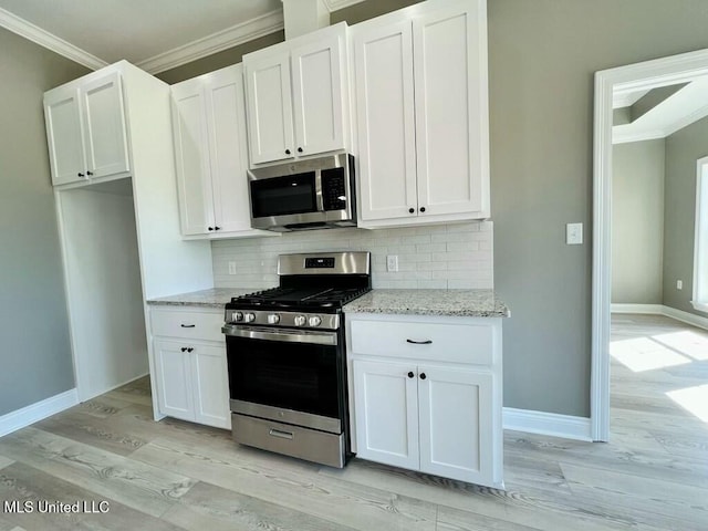 113 River Bend Ave, Vidalia, LA 71373 - kitchen with light stone counters, backsplash, appliances with stainless steel finishes, ornamental molding, and white cabinetry