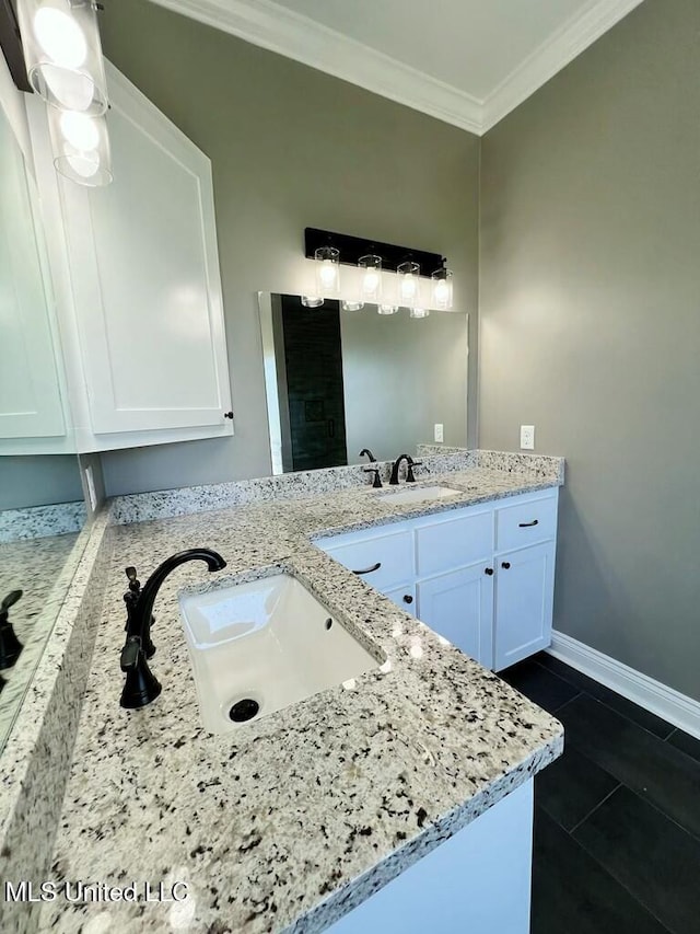 113 River Bend Ave, Vidalia, LA 71373 - bathroom featuring double vanity, ornamental molding, a sink, and baseboards