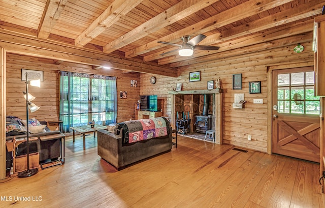 106 Mcwilliams Dr, Terry, MS 39170 - living room featuring a wood stove, beam ceiling, light wood-style floors, a ceiling fan, and wood ceiling