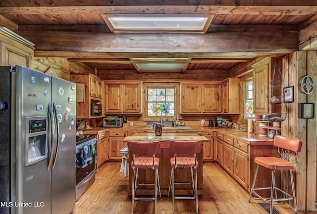 106 Mcwilliams Dr, Terry, MS 39170 - kitchen featuring stainless steel appliances, wooden ceiling, light wood-style flooring, beamed ceiling, and light countertops
