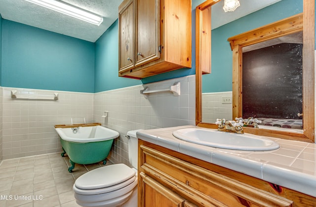 106 Mcwilliams Dr, Terry, MS 39170 - full bath with tile walls, a freestanding bath, vanity, toilet, and tile patterned flooring