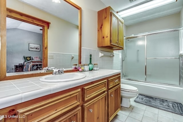 106 Mcwilliams Dr, Terry, MS 39170 - full bath with tile patterned flooring, toilet, vanity, and enclosed tub / shower combo