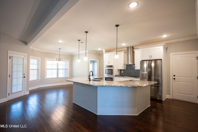 kitchen with wall chimney range hood, hanging light fixtures, stainless steel appliances, white cabinets, and dark hardwood / wood-style floors