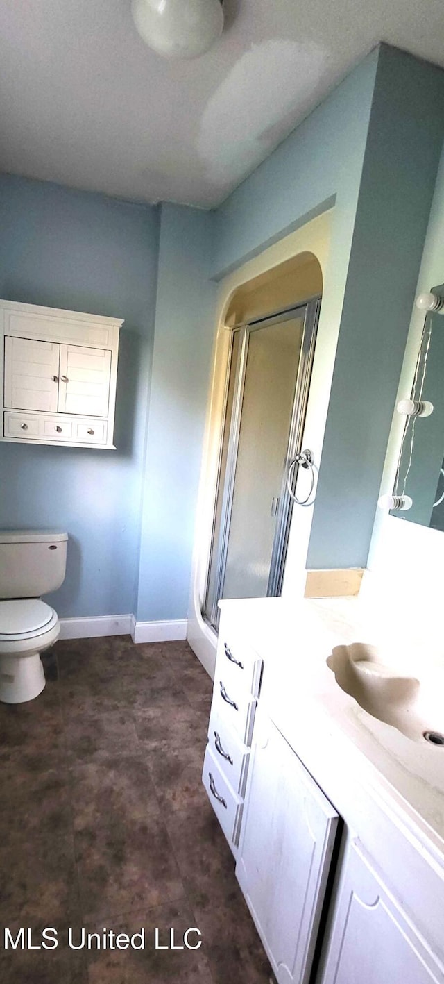 904 E Lakeshore Dr, Carriere, MS 39426 - bathroom with vanity, toilet, a shower stall, and baseboards