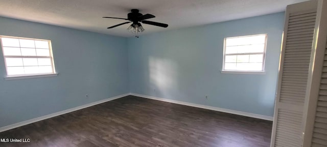 904 E Lakeshore Dr, Carriere, MS 39426 - unfurnished bedroom with dark wood finished floors, a closet, baseboards, and a ceiling fan