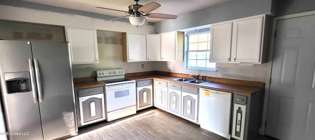 904 E Lakeshore Dr, Carriere, MS 39426 - kitchen with white appliances, a sink, white cabinetry, ceiling fan, and dark countertops