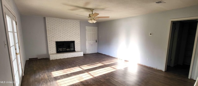 904 E Lakeshore Dr, Carriere, MS 39426 - unfurnished living room with a ceiling fan, wood finished floors, and a brick fireplace