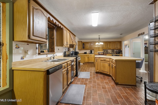 5539 Gates Ave, Long Beach, MS 39560 - kitchen with appliances with stainless steel finishes, a sink, butcher block counters, a chandelier, and a textured ceiling