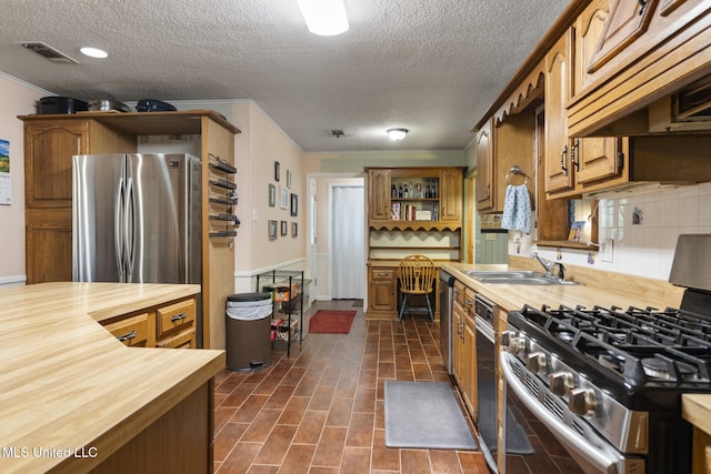 5539 Gates Ave, Long Beach, MS 39560 - kitchen featuring butcher block countertops, stainless steel appliances, premium range hood, open shelves, and a sink