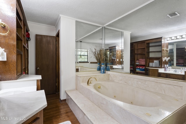 5539 Gates Ave, Long Beach, MS 39560 - bathroom featuring vanity, wood finished floors, a whirlpool tub, a textured ceiling, and ornamental molding