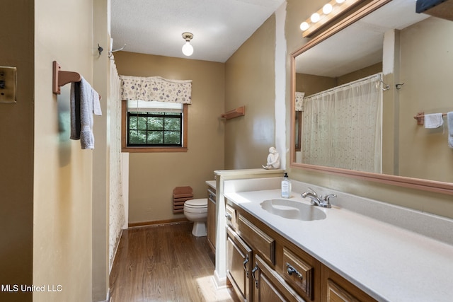 5539 Gates Ave, Long Beach, MS 39560 - bathroom featuring vanity, toilet, wood finished floors, and baseboards