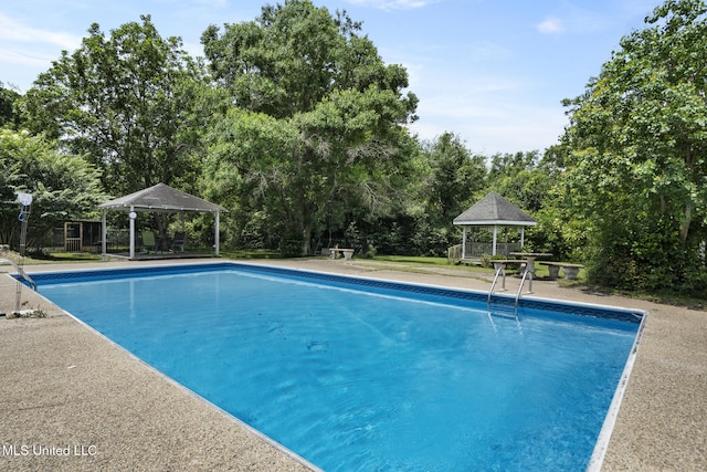 5539 Gates Ave, Long Beach, MS 39560 - swimming pool featuring a gazebo and view of wooded area